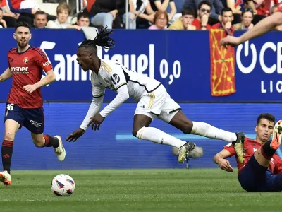 Real Madrid's David Alaba is fouled by Osasuna's Lucas Torrom during the Spanish La Liga soccer match between Osasuna and Real Madrid at the El Sadar stadium in Pamplona, Spain, Saturday, March 16, 2023. (AP Photo/Alvaro Barrientos)