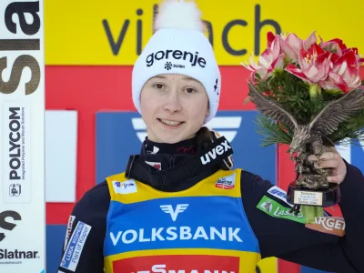 Gold medal winner Slovenia's Nika Prevc poses on the podium at the Women Normal Hill Individual Ski Jumping World Cup event in Villach, Austria, Thursday, Jan. 4, 2024. (AP Photo/Darko Bandic)