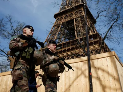 Armed French soldiers patrol at the Eiffel Tower as part of the "Vigipirate" security plan as France raises terror alert warning to the highest level, after the Moscow attack, in Paris, France, March 25, 2024. REUTERS/Benoit Tessier