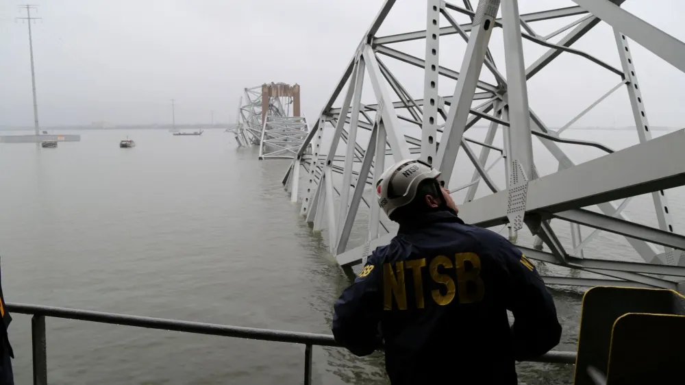 A National Transportation Safety Board (NTSB) worker looks on at the cargo vessel Dali, which struck and collapsed the Francis Scott Key Bridge, in Baltimore, Maryland, U.S. March 27, 2024. Peter Knudson/NTSB/Handout via REUTERS  THIS IMAGE HAS BEEN SUPPLIED BY A THIRD PARTY