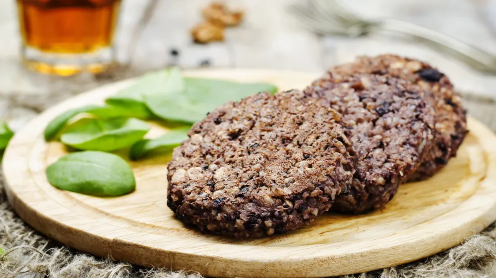 ﻿black beans brown rice walnut oat burgers with spinach. toning. selective focus