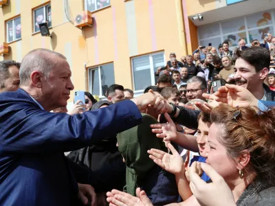 Turkish President Tayyip Erdogan greets his supporters as he leaves a polling station during the local elections in Istanbul, Turkey March 31, 2024. Murat Kulu/PPO/Handout via REUTERS THIS IMAGE HAS BEEN SUPPLIED BY A THIRD PARTY. NO RESALES. NO ARCHIVES