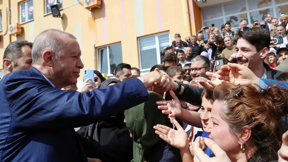 Turkish President Tayyip Erdogan greets his supporters as he leaves a polling station during the local elections in Istanbul, Turkey March 31, 2024. Murat Kulu/PPO/Handout via REUTERS THIS IMAGE HAS BEEN SUPPLIED BY A THIRD PARTY. NO RESALES. NO ARCHIVES