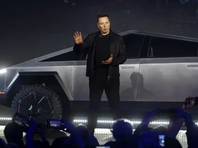 ﻿Tesla CEO Elon Musk introduces the Cybertruck at Tesla's design studio Thursday, Nov. 21, 2019, in Hawthorne, Calif. Musk is taking on the workhorse heavy pickup truck market with his latest electric vehicle. (AP Photo/Ringo H.W. Chiu)
