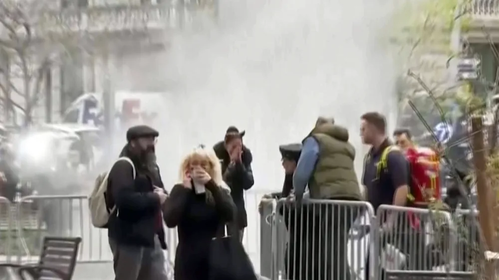 In this image taken from video, bystanders react after witnessing a man who lit himself on fire was extinguished, Friday, April 19, 2024, in a park outside Manhattan criminal court in New York. Emergency crews rushed away a person on a stretcher after the fire was extinguished outside the courthouse where jury selection was taking place in former President Donald Trump's hush money criminal case. (AP Photo)