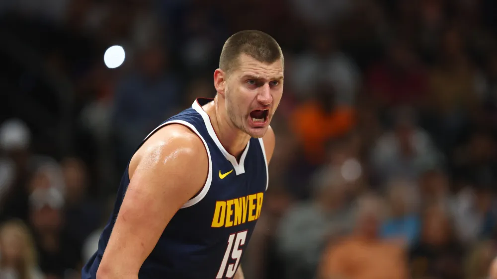 Oct 10, 2023; Phoenix, Arizona, USA; Denver Nuggets center Nikola Jokic (15) reacts against the Phoenix Suns during a preseason game at Footprint Center. Mandatory Credit: Mark J. Rebilas-USA TODAY Sports