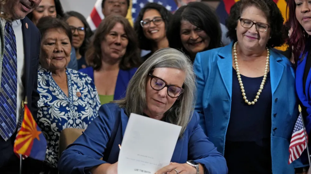 Arizona Gov. Katie Hobbs, D, signs the repeal of the Civil War-era near-total abortion ban, Thursday, May 2, 2024, at the Capitol in Phoenix. Democrats secured enough votes in the Arizona Senate to repeal the ban on abortions that the state's highest court recently allowed to take effect. (AP Photo/Matt York)