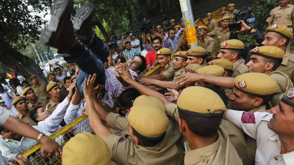 Indian police personnel push a supporter of India's main opposition Bharatiya Janata Party (BJP) who was trying to cross over the barricade during a protest outside the residence of Delhi's Chief Minister Sheila Dixit in New Delhi April 23, 2013. Indian police arrested a second man on Monday in connection with the rape and torture of a five-year-old girl in New Delhi, but that was not enough to halt protests at perceived police incompetence and corruption. REUTERS/Adnan Abidi (INDIA - Tags: CIVIL UNREST CRIME LAW TPX IMAGES OF THE DAY)