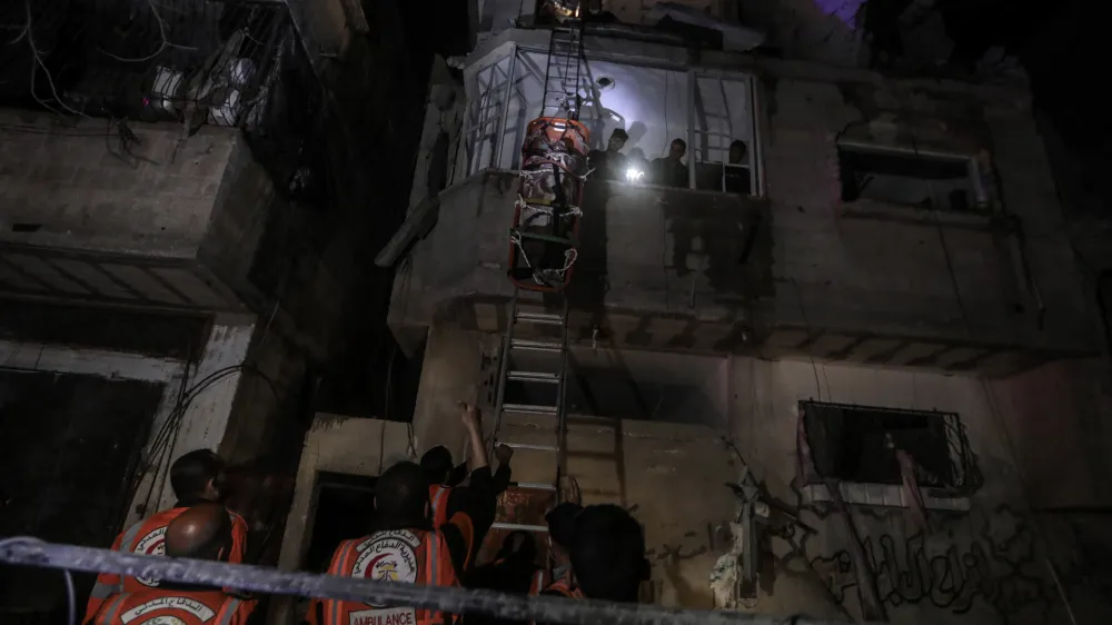 Palestinian civil defence members evacuate survivors of the Israeli bombardment on a residential building of Abu Alenan family in Rafah, southern Gaza Strip, early Saturday, May 4, 2024. (AP Photo/Ismael Abu Dayyah)