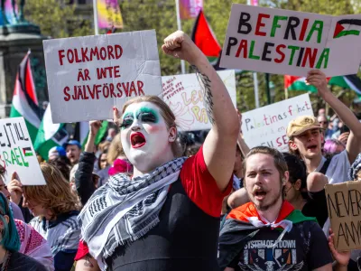 11 May 2024, Sweden, Malmo: Protesters hold placards and shout slogans during a Pro-Palestine rally before the final of the Eurovision Song Contest (ESC) 2024. Photo: Jens Büttner/dpa