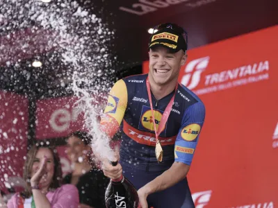 Italy's Jonathan Milan celebrates on podium after winning the 11th stage of the Giro d'Italia, Tour of Italy cycling race, from Foiano di Val Fortore to Francavilla al Mare, Italy, Wednesday, May 15, 2024. (Massimo Paolone/LaPresse via AP)