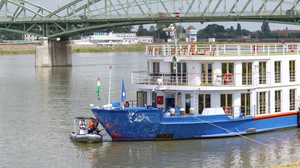 Police investigators examine the bow of a river cruise ship after an incident, in Komarom, Hungary, Sunday, May 19, 2024. Police say two people have died and five are missing following a boat collision on the Danube River in Hungary. Hungarian police received a report late Saturday night that a man had been found with a head injury on the shore of the Danube near the town of Veroce, around 30 miles (50 kilometers) north of the capital, Budapest. (Peter Lakatos/MTI via AP)
