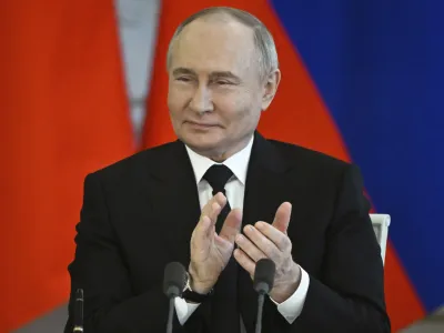 Russian President Vladimir Putin applauds as he attends a signing ceremony following his talks with Bahrain's Crown Prince and Prime Minister Salman bin Hamad bin Isa Al Khalifa at the Kremlin in Moscow, Russia, Thursday May 23, 2024. (Sergei Guneyev, Sputnik, Kremlin Pool Photo via AP)