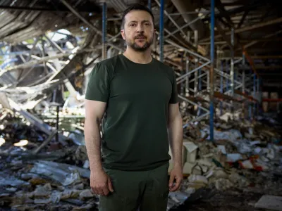 Ukrainian President Volodymyr Zelenskiy stands inside a printworks compound, destroyed on Thursday in a Russian airstrike, during his appeal to U.S. President Joe Biden and Chinese President Xi Jinping to join an upcoming peace summit, amid Russia's attack on Ukraine, in Kyiv, Ukraine May 26, 2024. Ukrainian Presidential Press Service/Handout via REUTERS ATTENTION EDITORS - THIS IMAGE HAS BEEN SUPPLIED BY A THIRD PARTY.