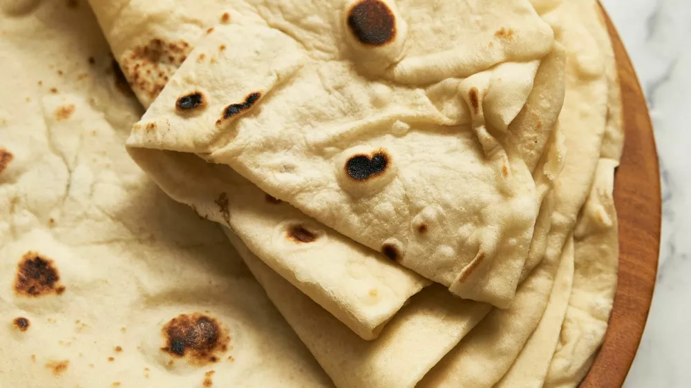Soft lavash bread on white background. Homemade freshy baked lavash bread is perfect for kebabs, shawarma and other dishes. Only water, yeast, flour and salt. High quality photo / Foto: Alexbai