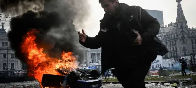 A car burns during a protest near the National Congress, on the day Senators debate Argentina's President Javier Milei's economic reform bill, known as the "omnibus bill", in Buenos Aires, Argentina, June 12, 2024. REUTERS/Mariana Nedelcu