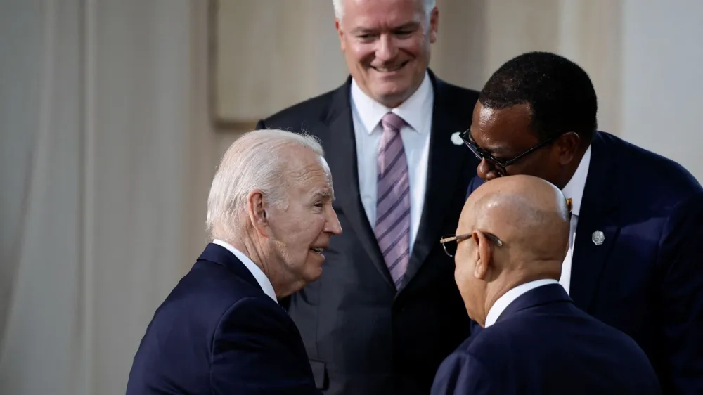 U.S. President Joe Biden, African Development Bank President Akinwumi Adesina, and OECD Secretary General Mathias Cormann stand together, on the second day of the G7 summit at the Borgo Egnazia resort, in Savelletri, Italy June 14, 2024. REUTERS/Louisa Gouliamaki