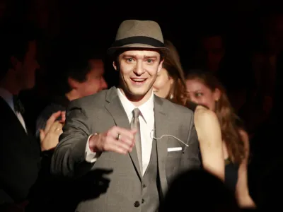 Actor, song writer and pop musician Justin Timberlake greets members of the audience before being presented with the Hasty Pudding Man of the Year on the school's campus, in Cambridge, Mass., Friday, Feb. 5, 2010. Timberlake, a Grammy and Emmy award winner, received the pudding pot from the nation's oldest undergraduate drama troupe during a roast Friday. (AP Photo/Steven Senne)