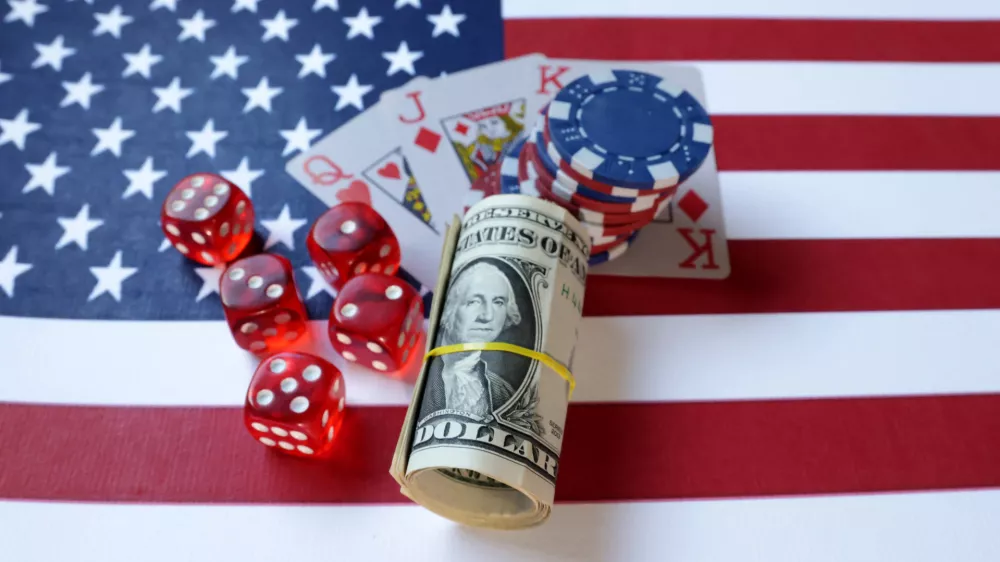 Cards, gambling dices, U.S. dollar banknotes and U.S. flag are seen in this illustration taken, June 17, 2024. REUTERS/Dado Ruvic/Illustration