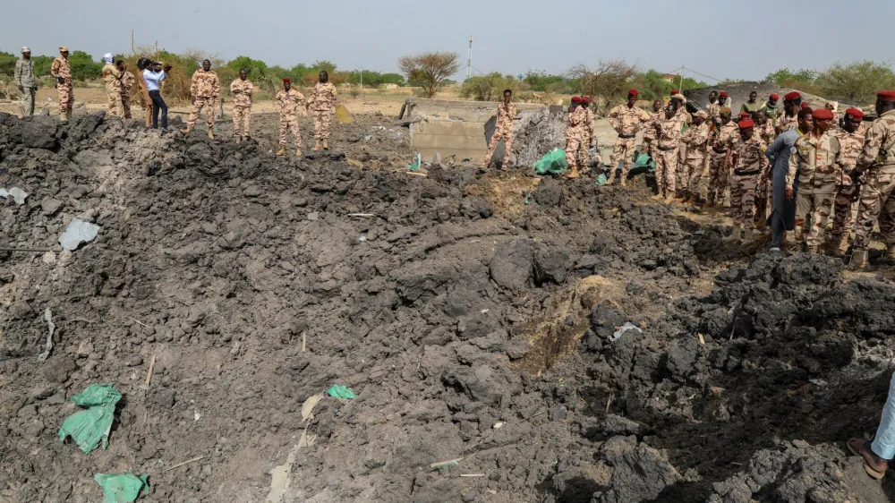Army officers stand around blast damages after last night's fire that caused blasts at a military ammunition depot in N'Djamena, Chad June 19, 2024. REUTERS/Israel Matene