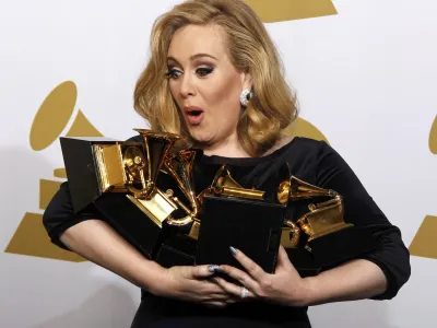 Singer Adele holds her six Grammy Awards at the 54th annual Grammy Awards in Los Angeles, California February 12, 2012. Soul singer Adele triumphed in her return to music's stage on Sunday, scooping up six Grammys and winning every category in which she was nominated including album of the year for "21" and best record with "Rolling In the Deep."  REUTERS/Lucy Nicholson (UNITED STATES - Tags: ENTERTAINMENT TPX IMAGES OF THE DAY) (GRAMMYS-BACKSTAGE)