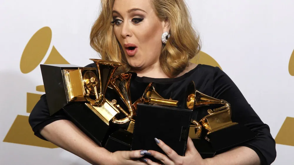 Singer Adele holds her six Grammy Awards at the 54th annual Grammy Awards in Los Angeles, California February 12, 2012. Soul singer Adele triumphed in her return to music's stage on Sunday, scooping up six Grammys and winning every category in which she was nominated including album of the year for "21" and best record with "Rolling In the Deep."  REUTERS/Lucy Nicholson (UNITED STATES - Tags: ENTERTAINMENT TPX IMAGES OF THE DAY) (GRAMMYS-BACKSTAGE)