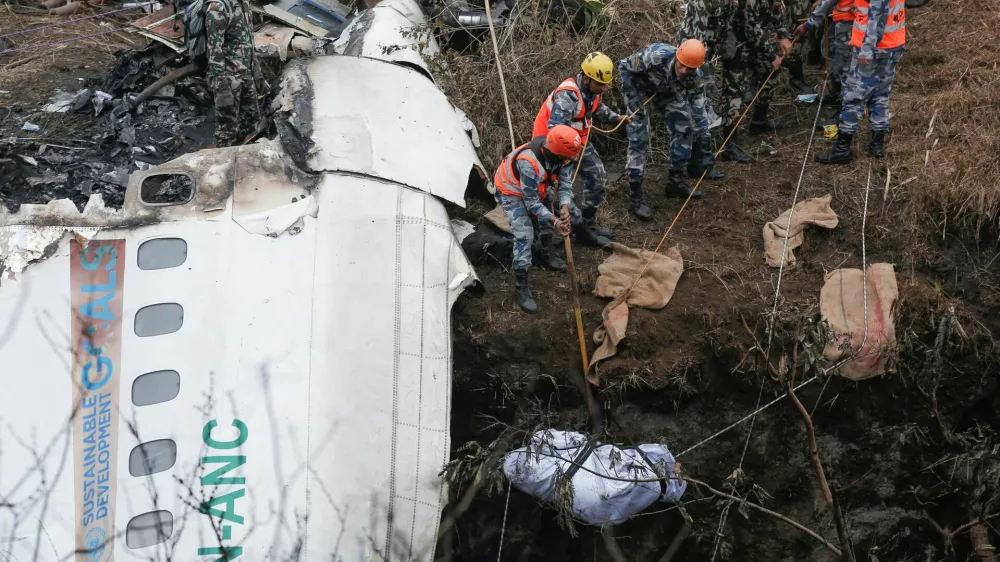 A rescue team recovers the body of a victim from the site of the plane crash of a Yeti Airlines operated aircraft, in Pokhara, Nepal January 16, 2023. REUTERS/Rohit Giri NO RESALES. NO ARCHIVES