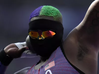 Raven Saunders, of the United States, competes during the women's shot put qualification at the 2024 Summer Olympics, Thursday, Aug. 8, 2024, in Saint-Denis, France. (AP Photo/Ashley Landis)