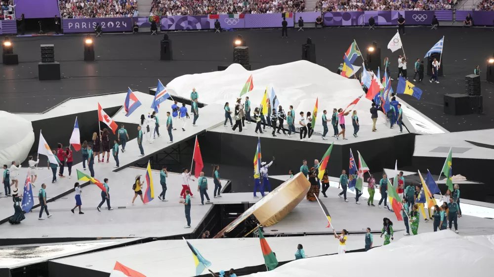 Athletes parade during the 2024 Summer Olympics closing ceremony at the Stade de France, Sunday, Aug. 11, 2024, in Saint-Denis, France. (AP Photo/Martin Meissner)
