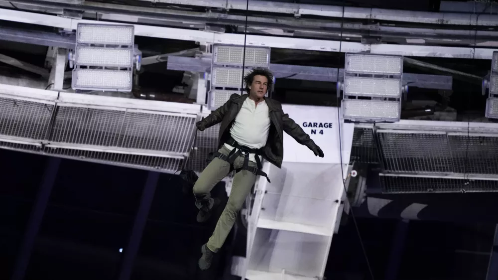 Tom Cruise is lowered to the Stade de France during the 2024 Summer Olympics closing ceremony, Sunday, Aug. 11, 2024, in Saint-Denis, France. (AP Photo/Natacha Pisarenko)