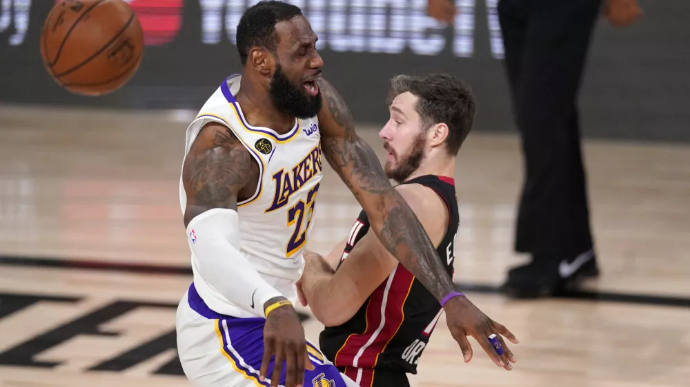 ﻿Los Angeles Lakers' LeBron James (23) collides with Miami Heat's Goran Dragic (7) during the first half in Game 6 of basketball's NBA Finals Sunday, Oct. 11, 2020, in Lake Buena Vista, Fla. (AP Photo/Mark J. Terrill)