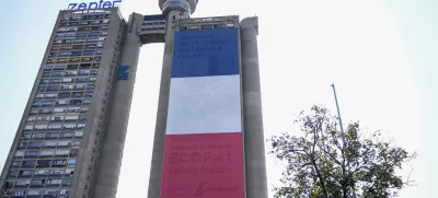 A giant French national flag on a skyscraper that is a symbolic gateway leading into the city from the airport, in Belgrade, Serbia, Thursday, Aug. 29, 2024. French President Emmanuel Macron starts a two-day state visit to Serbia on Thursday. (AP Photo/Darko Vojinovic)