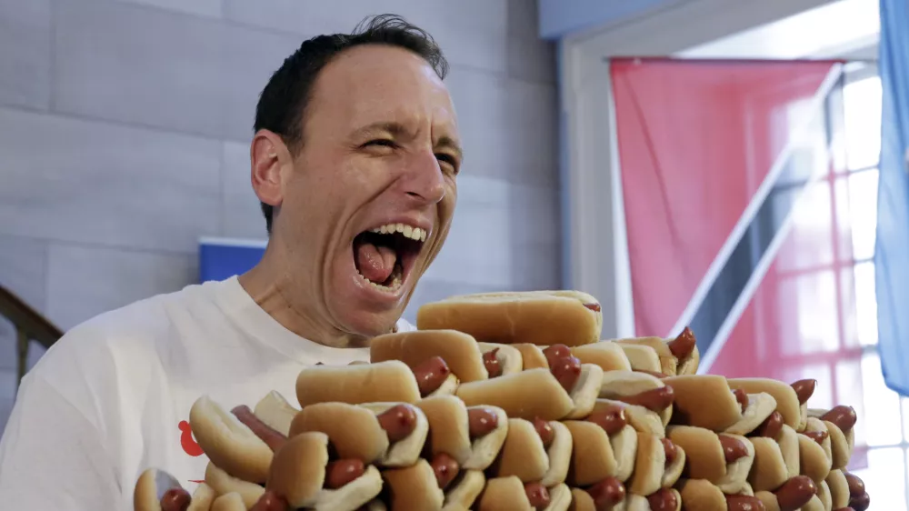 Current men's champion Joey Chestnut, of San Jose, Calif., holds a tray of hot dogs during the weigh-in for the 2017 Nathan's Hot Dog Eating Contest, in Brooklyn Borough Hall, in New York, Monday, July 3, 2017. Chestnut weighed-in at 221.5 pounds. (AP Photo/Richard Drew)