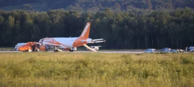 In this June 10, 2017 photo taken from video, a EasyJet plane stands at Cologne-Bonn airport, in Cologne Germany. German police are questioning three British citizens after their conversation during a flight to London prompted an EasyJet pilot to make an unscheduled stop in Cologne late Saturday. A spokesman for Cologne police says other passengers on the flight from the Slovenian capital Ljubljana overheard a conversation with "terrorist content" between the men, aged 31, 38 and 48. Airport authorities said in a statement that the 151 passengers on board disembarked the plane using emergency slides. (Thomas Kraus/dpa via AP)