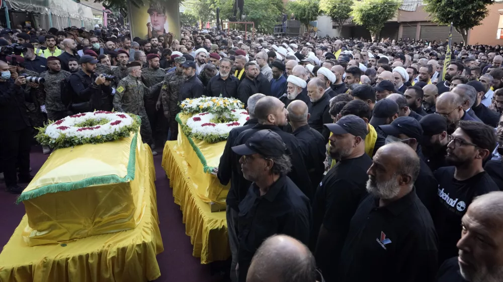 Hezbollah's deputy leader Naim Kassem, centre, speaks during the funeral of Hezbollah commander Ibrahim Akil and militant Mahmoud Hamad in Beirut's southern suburb, Sunday, Sept. 22, 2024. (AP Photo/Bilal Hussein)
