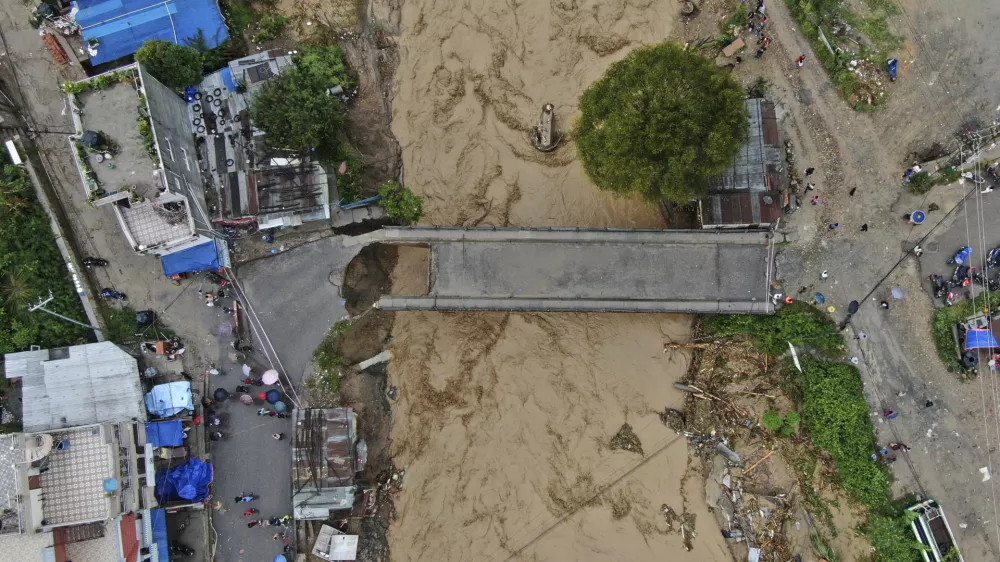 In this aerial image of the Kathmandu valley, Bagmati River is seen in flood due to heavy rains in Kathmandu, Nepal, Saturday, Sept. 28, 2024. (AP Photo/Gopen Rai)