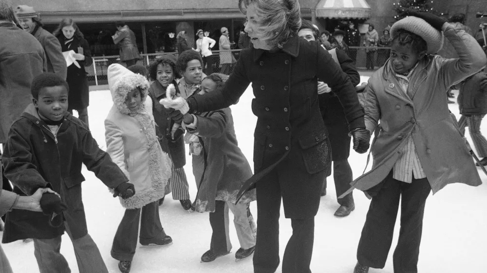 FILE - Ethel Kennedy, widow of Sen. Robert Kennedy, ice skates with youngsters from Bedford Stuyvesant, Brooklyn borough, at the eighth annual Kennedy skating party originated by the late senator at Rockefeller Center's skating rink on Dec. 16, 1972, in New York. (AP Photo, File) 