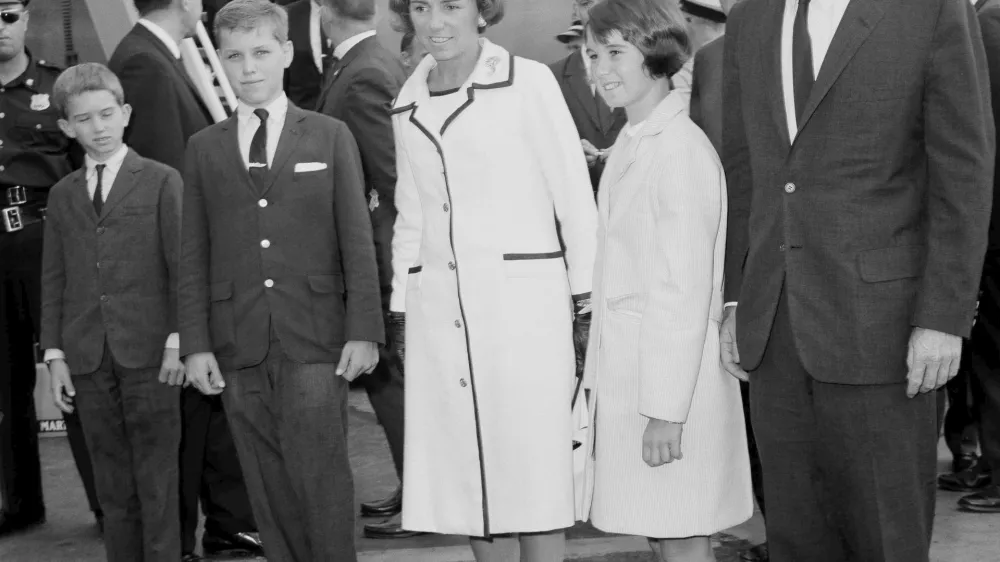 FILE - Attorney General Robert F. Kennedy, right, wife Ethel Kennedy, and children, from left, Bobby, Joseph, and Kathleen, second right, pose at Kennedy International Airport in New York, July 1, 1964, shortly after they returned from a one-week trip to West Germany and Poland. (AP Photo/Matty Zimmerman, File)