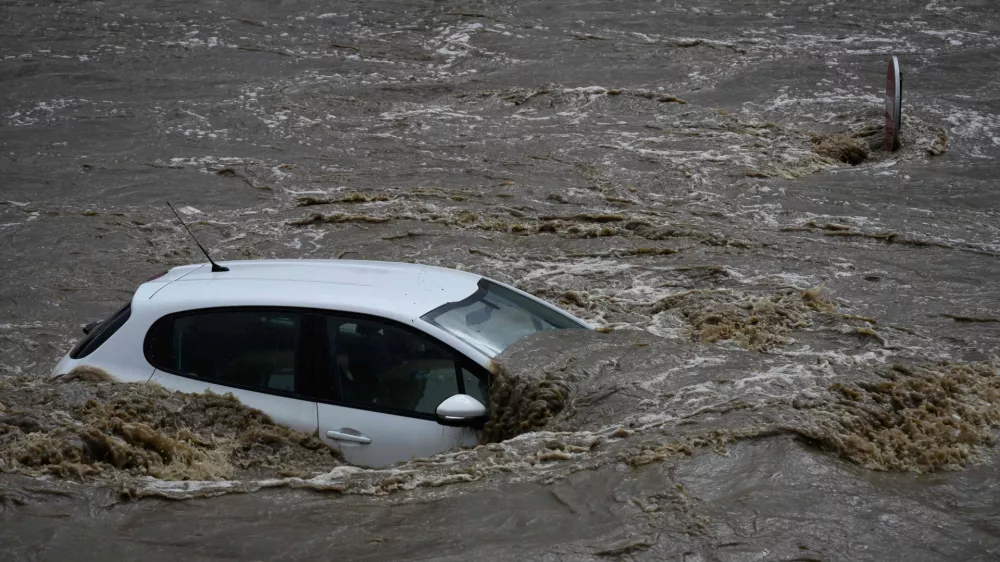 17 October 2024, France, Givors: A flooded car stands in an industrial estate after heavy rainfall in the region. Photo: Jean-Philippe Ksiazek/AFP/dpa