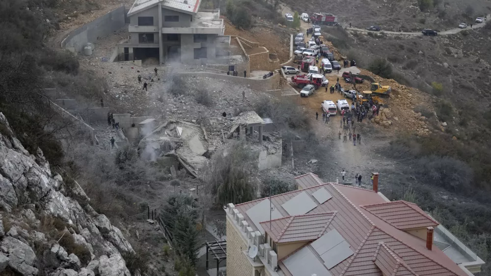 Rescue workers search for victims at a house hit in an Israeli airstrike in Baalchmay village east of Beirut, Lebanon, Tuesday, Nov. 12, 2024. (AP Photo/Hassan Ammar)