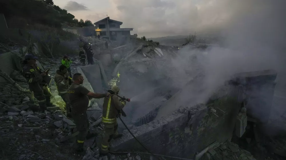 Lebanese Red Cross volunteers and other rescuers search for victims at a house that was hit in an Israeli airstrike in Baalchmay village east of Beirut, Lebanon, Tuesday, Nov. 12, 2024. (AP Photo/Hassan Ammar)