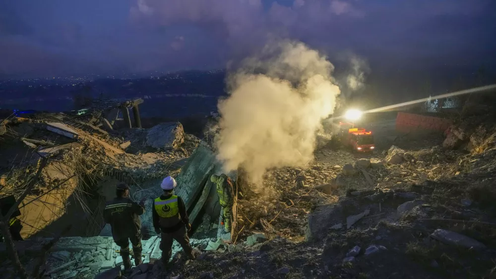 Lebanese Red Cross volunteers and other rescuers search for victims at a house hit in an Israeli airstrike in Baalchmay village east of Beirut, Lebanon, Tuesday, Nov. 12, 2024. (AP Photo/Hassan Ammar)