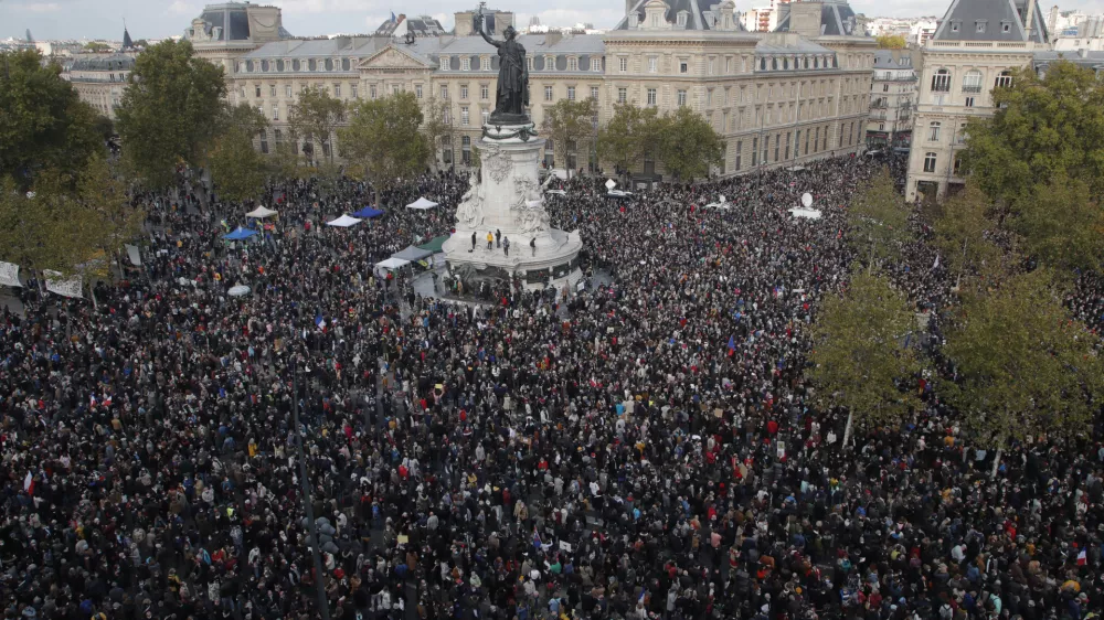 FILE - Hundreds of people gather on Republique square during a demonstration Sunday Oct. 18, 2020 in Paris, in support of freedom of speech and to pay tribute to French history teacher Samuel Paty. (AP Photo/Michel Euler, File)
