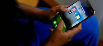 A high school student poses with her mobile showing her social media applications in Melbourne, Australia, November 28, 2024. REUTERS/Asanka Brendon Ratnayake