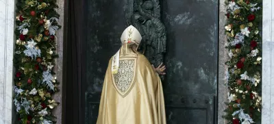 Cardinal Baldassare Reina opens the Holy Door of Rome's St. John in Lateran Basilica as part of the celebrations for the 2025 Jubilee of the Catholic Church, Sunday, Dec. 29, 2024. (Angelo Carconi/Pool Photo via AP)
