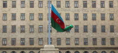 FILE PHOTO: An Azeri state flag flies at half-mast as the country observes day of national mourning for the victims of an Azerbaijan Airlines' Embraer passenger plane crash near the Kazakh city of Aktau, outside the Government House in Baku, Azerbaijan, December 26, 2024. REUTERS/Aziz Karimov/File Photo