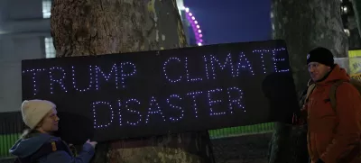 Demonstrators hold a placard that reads "Trump Climate Disaster" during a protest against the inauguration of Donald Trump as U.S. president, in London, Britain, January 20, 2025. REUTERS/Isabel Infantes