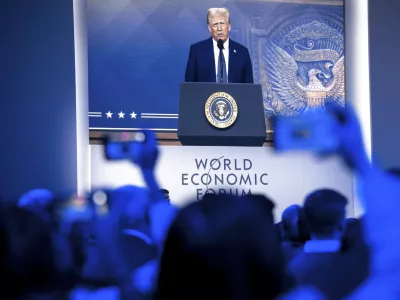 US President Donald J. Trump is shown on screens as he addresses via remote connection a plenary session in the Congress Hall, during the 55th annual meeting of the World Economic Forum (WEF), in Davos, Switzerland, Thursday, Jan. 23, 2025. (Laurent Gillieron/Keystone via AP)