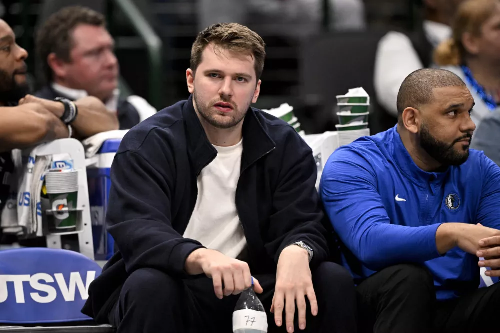 Jan 12, 2025; Dallas, Texas, USA; Dallas Mavericks guard Luka Doncic (77) reacts from the team bench during the second half of the game against the Denver Nuggets at the American Airlines Center. Mandatory Credit: Jerome Miron-Imagn Images
