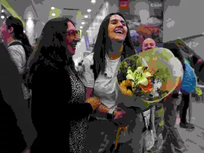 Edita Bizama laughs with her daughter Adamary Garcia, one of the victims of Pinochet-era forced adoptions, at the airport in Santiago, Chile February 22, 2025. REUTERS/Pablo Sanhueza
